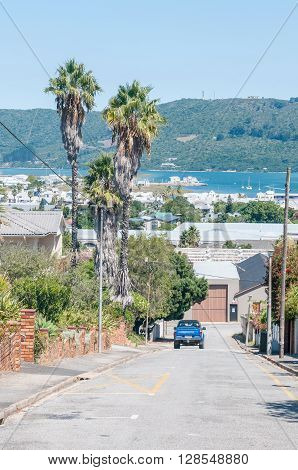 KNYSNA SOUTH AFRICA - MARCH 3 2016: A street view of Knysna with the Regional Office of the South African National Parks Board on the historic Thesens Island in the back