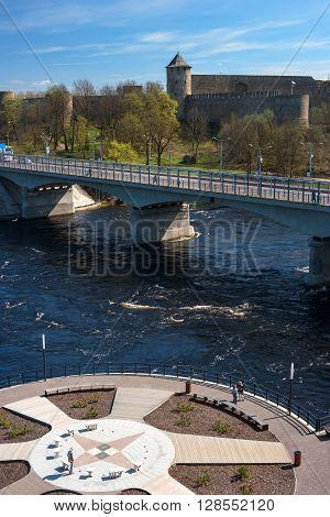 Ivangorod-Narva, Estonia-Russia - May 4, 2016: ancient fortress at the border of Russia and Estonia. The Two Towers shares the Narva River. In the foreground promenade.