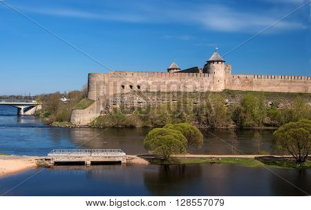 Ivangorod. ancient fortress at the border of Russia and Estonia. The Two Towers shares the Narva River. In the foreground a pond Lime Pit.