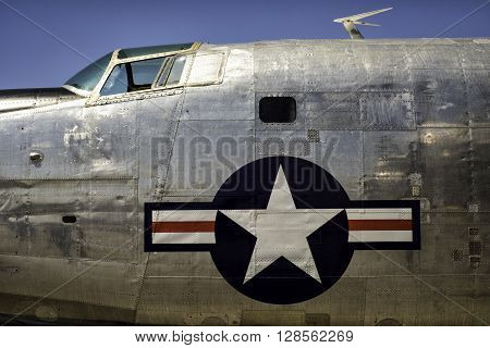 Vintage plane fuselage with large United States retro Air corps insignia.