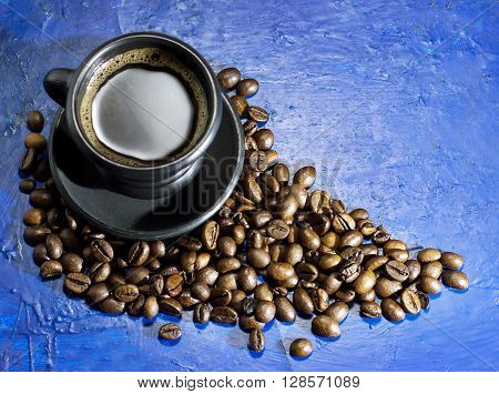 A cup of hot coffee on the old blue background
