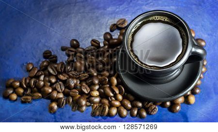 A cup of hot coffee on the old blue background