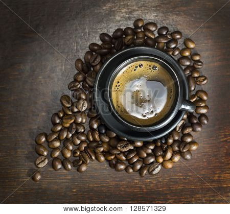 A cup of hot coffee on wooden background