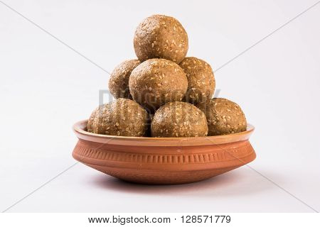 The indian sesame sweet or tilgul laddu, made up of jaggery and sesame seeds, hand made, round, indian sweet prepared in Makar Sankranti festival