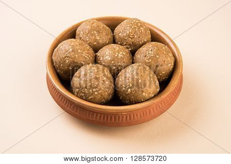 The indian sesame sweet or tilgul laddu, made up of jaggery and sesame seeds, hand made, round, indian sweet prepared in Makar Sankranti festival