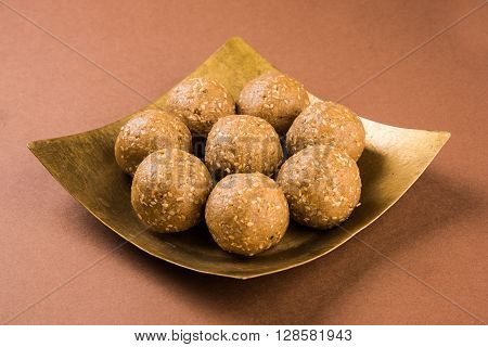 The indian sesame sweet or tilgul laddu, made up of jaggery and sesame seeds, hand made, round, indian sweet prepared in Makar Sankranti festival,
