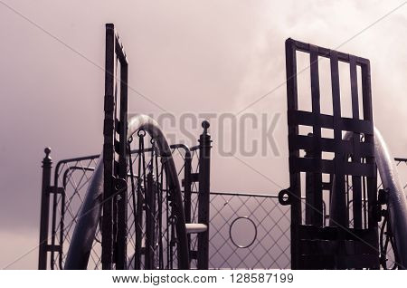Metal gate with simple decorations sorrounded by misty and foggy spectacular mountain view in Quito Ecuador.
