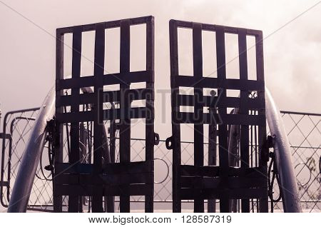 Metal gate with simple decorations sorrounded by misty and foggy spectacular mountain view in Quito Ecuador.