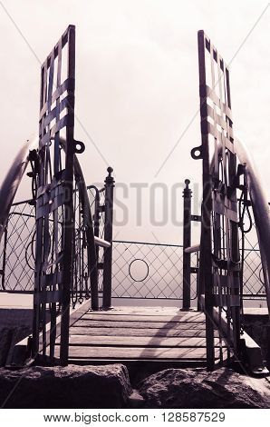 Metal gate with simple decorations sorrounded by misty and foggy spectacular mountain view in Quito Ecuador.
