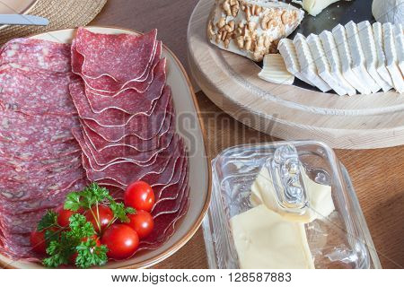 Different types of cheese on the table. Homework healthy breakfast. Diet food. Breakfast for children. Well-laid wooden table.
