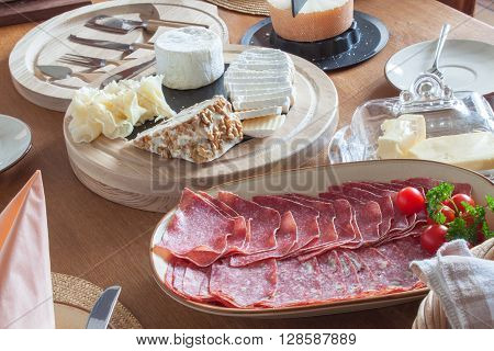 Different types of cheese on the table. Homework healthy breakfast. Diet food. Breakfast for children. Well-laid wooden table.