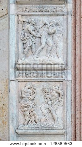 BOLOGNA, ITALY - JUNE 04: Expulsion from Paradise up, the work of Adam and Eve down, panel by Jacopo della Quercia on the central door of San Petronio Basilica in Bologna, Italy, on June 04, 2015