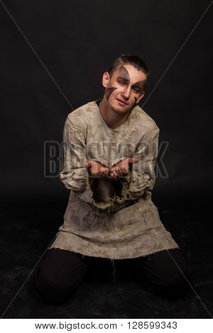 Actor in makeup a poor man in a suit