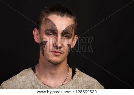 Actor in makeup a poor man in a suit