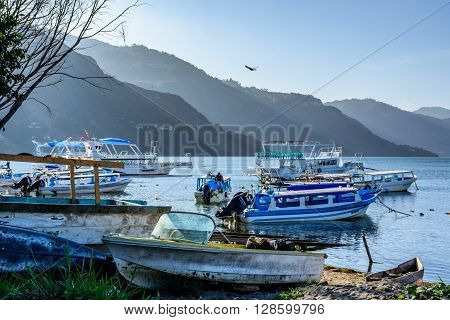 Lake Atitlan Guatemala - April 3 2016: Early morning light on moored boats at edge of Lake Atitlan, Guatemala.