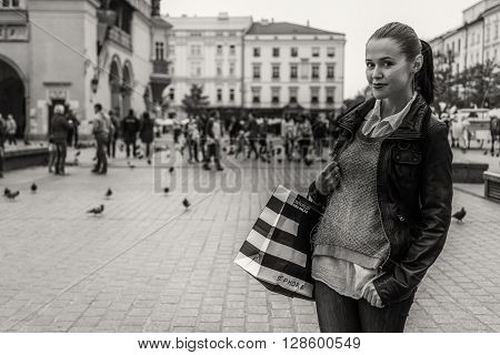 KRAKOW POLAND - SEPTEMBER 25: Shopping in Krakow. Young girl doing shopping Poland on September 25 2015