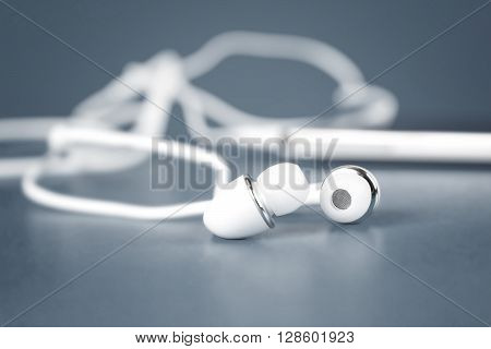 selective focus of the white earphones for using with digital music or smart phone