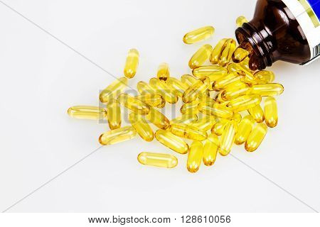 Closeup the yellow soft gelatin supplement fish oil capsule