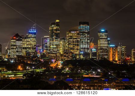 Sydney Australia - November 10 2014: Unusual night view of Sydney central business district. Royal Botanic Gardens in the center Sydney New South Wales Australia