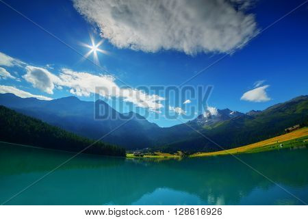 Amazing sunny day at Champferersee lake in the Swiss Alps. Silvaplana village, Switzerland, Europe.