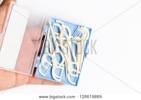 Oral Device : Dental Flossers On White Paper Background