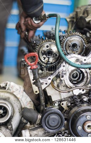 Hands Repairing A Car Engine With A Wrench
