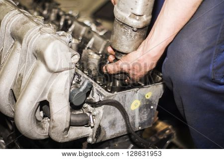 Hands Repairing A Car Engine With A Wrench