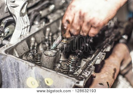 Hands Repairing A Car Engine With A Wrench