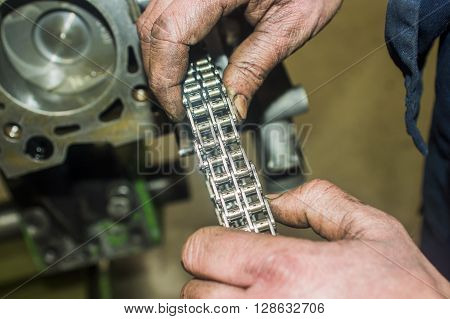 Hands Repairing A Car Engine With A Wrench