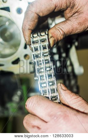 Hands Repairing A Car Engine With A Wrench