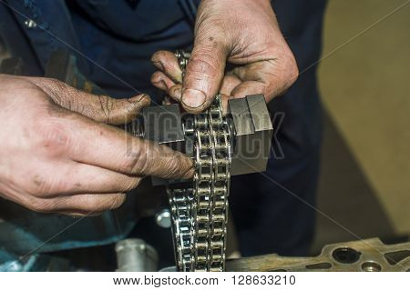 Hands Repairing A Car Engine With A Wrench