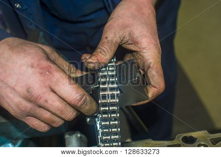 Hands Repairing A Car Engine With A Wrench