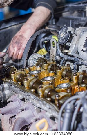 Hands Repairing A Car Engine With A Wrench