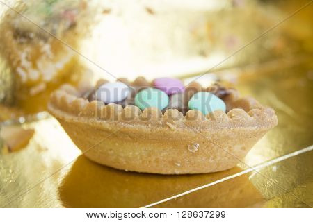 closeup of a pastry with chocolate cream and colored comfit