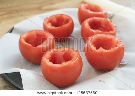 preparing tomatoes stuffed with rice with the removal of the pulp and the seeds