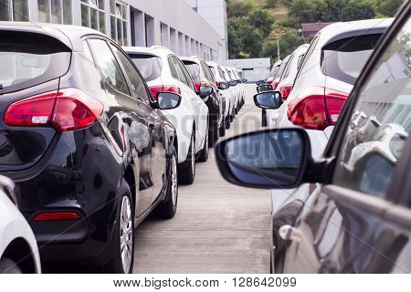 A Row Of New Cars Parked At A Car Dealer Shop