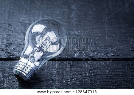 Tungsten bulb on a black wooden table