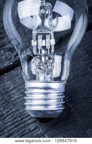 Tungsten bulb on a black wooden table
