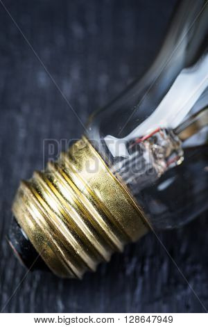 Tungsten bulb on a black wooden table