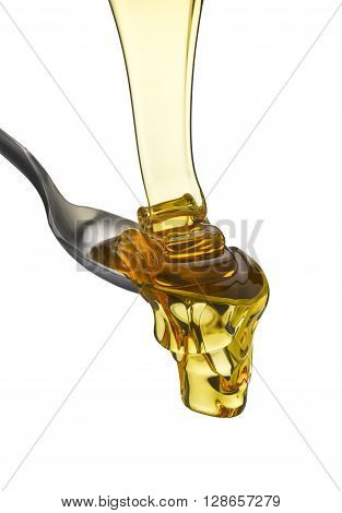 Golden treacle flowing onto a spoon isolated on a white background