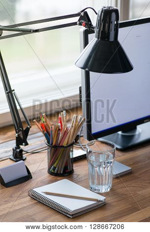 Light And Cozy Workplace With Glass Of Water