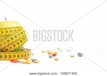 Fresh Green Apple With Measuring Tape And Pills