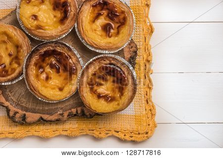Pasteis de nata typical Portuguese egg tart pastries on a set table. Top view with copy space