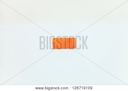 Retroreflector on white background. Small reflecting light cataphote.