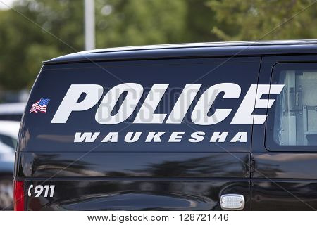 WAUKESHA WI/USA - July 13 2015: A Waukesha police van is parked in front of the Waukesha Convention Center during a progressive political protest against Governor Scott Walker.