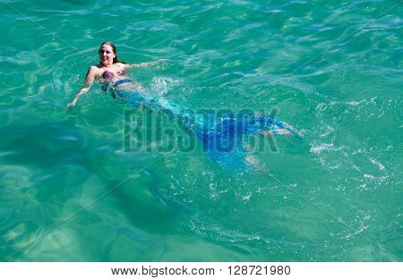 COOGEE,WA,AUSTRALIA-APRIL 3,2016: Live interactive mermaid floating in the Indian Ocean waters at the Coogee Beach Festival in Coogee, Western Australia.