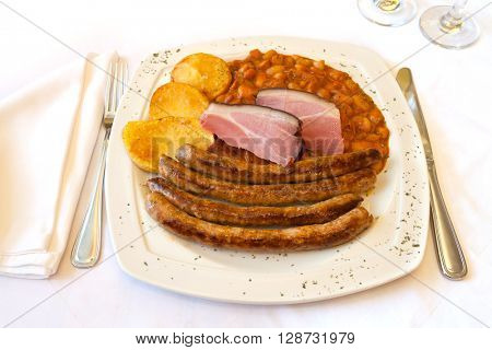 Traditional Croatian cuisine, homemade sausage from the tavern with beans and potatoes