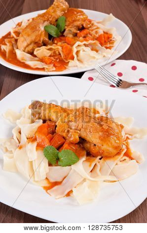 Image of delicious chicken drumsticks with macaroni