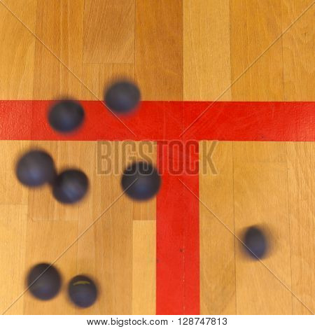 black squash balls on the sqash court
