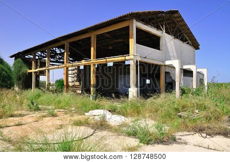 Ruined ramshackle building in abandoned industrial  zone.